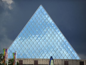 City Hall's main pyramid gleams in the light in front of a dark storm cloud in Edmonton on Sunday July 20, 2014.