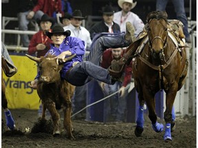 Cody Cassidy from Donalda, Alberta in the Steer Wrestling event at the 2015 Canadian Finals Rodeo in Edmonton on Friday November 13, 2015.