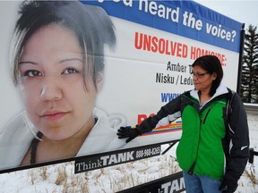 Amber Tuccaro's mother, Vivian Tuccaro, touches the photo of her deceased daughter at the unveiling of a billboard on Nov. 12, 2013, in hopes of advancing the homicide case. Her skull was found by horseback riders on a property near Leduc and she was reported missing in August 2010.