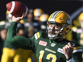 Edmonton Eskimos' Mike Reilly (13) throws for the pass during first half CFL playoff action against the Hamilton Tiger Cats, in Hamilton, Ont., on Sunday, November 13, 2016.