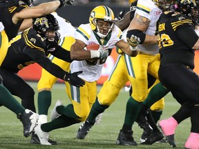 Edmonton Eskimos running back John White (30) runs for some yards during the second-half of CFL football action against the Hamilton Tiger-Cats in Hamilton on Friday, October 28, 2016.