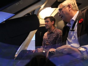 Edmonton Mayor Don Iveson tests out the new helicopter simulator at Edmonton International alongside Mark Olson, FTD manager for Canadian Helicopters, Nov. 10, 2016. DAVE LAZZARINO/POSTMEDIA