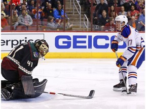 Edmonton Oilers center Connor McDavid (97) scores a goal against Arizona Coyotes goalie Mike Smith (41) during the first period of an NHL hockey game Friday, Nov. 25, 2016, in Glendale, Ariz.