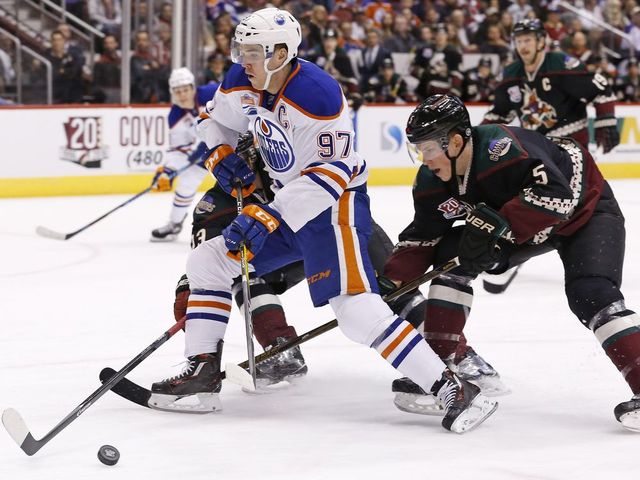 Edmonton Oilers center Connor McDavid (97) tries to skate past Arizona Coyotes defenseman Connor Murphy (5) during the first period of an NHL hockey game Friday, Nov. 25, 2016, in Glendale, Ariz.