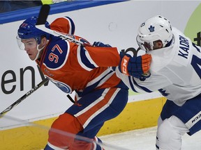 Edmonton Oilers Connor McDavid (97) gets a stick up high courtesy of Toronto Maple Leafs Nazem Kadri (43) during second period action.