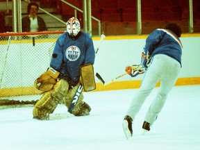 Edmonton Oilers goalie Grant Fuhr faces a shot during practice at Northlands Coliseum in an undated photo.