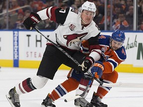 Edmonton Oilers Kris Russell (4) and Arizona Coyotes Lawson Crouse (67) battle for the puck during first period NHL action on Sunday, November 27, 2016 in Edmonton.  Greg  Southam / Postmedia  () Photos off Oilers game for multiple writers copy in Nov. 28 editions.