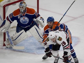 Edmonton Oilers Kris Russell (4) pushes Chicago Blackhawks Jonathan Toews (19) out of goalie Cam Talbot (33) way during first period NHL action on Monday, November 21, 2016 in Edmonton.  Greg  Southam / Postmedia  (For a sports  story.) Photos off Oilers game for multiple writers copy in Nov. 22 editions.
