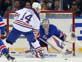 Jordan Eberle #14 of the Edmonton Oilers scores at 18:20 of the second period against Henrik Lundqvist #30 of the New York Rangers during the second period at Madison Square Garden on December 15, 2015 in New York City.