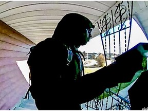 Edmonton police released a photo and video surveillance footage on Wednesday, Nov. 30, 2016 of an individual they believe may be responsible for the recent distribution of hatred flyers across the city. The picture was taken on Oct. 22, 2016 from a north-end residence in Evansdale.