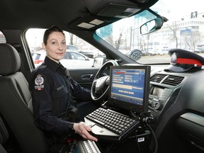 Edmonton Police Service Const. Kate Johnson with the eCruiser installed in her police vehicle, a new tool that allows police to create electronic collision reports on the scene from their vehicles.