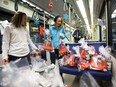 Students from McKernan School place hampers on an LRT train during the Stuff-a-Bus campaign launch at the D.L. MacDonald Yard in Edmonton on Tuesday, Nov. 29, 2016.