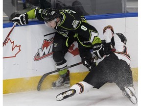 Edmonton's Ethan Cap (left) knocks down Calgary's Mark Kastelic during the first period of a WHL game between the Edmonton Oil Kings and the Calgary Hitmen at Rogers Place in Edmonton, Alberta on Friday, October 28, 2016. The Oil Kings lost 3-1 to the Moose Jaw Warriors on Friday.