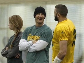 Edmonton's head coach Jason Maas (centre) and quarterback Mike Reilly (13) chat during an Edmonton Eskimos practice in the Field House at Commonwealth Community Recreation Centre in Edmonton, Alberta on Wednesday, November 2, 2016.