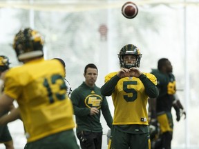 Edmonton's quarterback Jordan Lynch, No. 5, throws a ball with quarterback Mike Reilly during an Edmonton Eskimos practice in the Field House at Commonwealth Community Recreation Centre in Edmonton, Alberta on Wednesday, November 2, 2016. Chicago native Lynch, a lifelong White Sox fan, cheered against his hometown Cubs during the World Series.