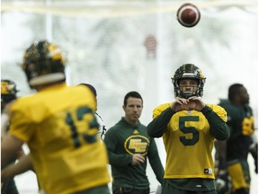 Edmonton's quarterback Jordan Lynch (5) throws a ball with quarterback Mike Reilly (13) during an Edmonton Eskimos practice in the Field House at Commonwealth Community Recreation Centre in Edmonton, Alberta on Wednesday, November 2, 2016.