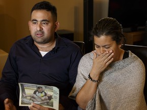 Elias Malkum and his wife Milena Duran hold the photo of Malkum's brother Leonardo Duran Ibanez while speaking about his loss at their home in Edmonton, Alberta on Wednesday, November 16, 2016.