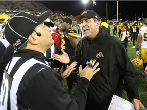 Hamilton Tiger-Cats head coach Kent Austin speaks with a referee following his team's loss to the Edmonton Eskimos during CFL football action in Hamilton on Friday, October 28, 2016.