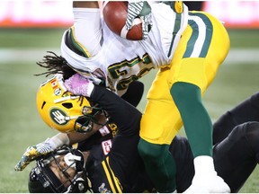 Edmonton Eskimos wide receiver Derel Walker (87) tries to fend off Hamilton Tiger-Cats' Chris Davis (25) during the second-half of CFL football action in Hamilton on Friday, October 28, 2016.