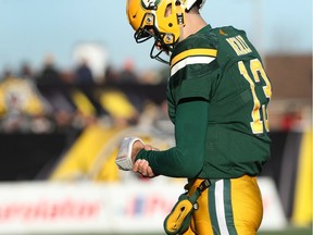 Edmonton Eskimos quarterback Mike Reilly (13) holds his wrist while walking off the field during the second-half of CFL eastern semi-final football action against the Hamilton Tiger Cats, in Hamilton, Ont., on Sunday, November 13, 2016.
