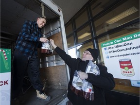 Dan "Can Man Dan" Johnstone (top) and a volunteer load donations during the start of his annual campaign in support of the Edmonton Food Bank, in Edmonton on Thursday Nov. 24, 2016. Dan will camp out in the cube van at the Southgate Mall Safeway, while accepting food and monetary donations for the Edmonton Food Bank.  Photo by David Bloom