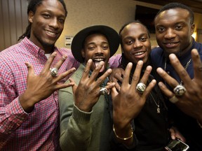 (left to right) Derel Walker, Shakir Bell, Anthony Barrett, and Deon Lacey show off their Grey Cup rings, in Edmonton Alta. on Friday May 27, 2016. Members of the Edmonton Eskimos received their Grey Cup rings during a private ceremony at the Chateau Nova Yellowhead Hotel, 13920 Yellowhead Trail. Photo by David Bloom