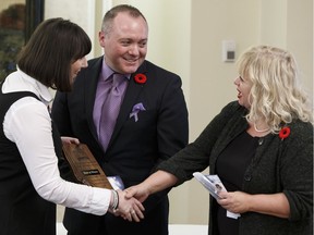 MLA Nicole Goehring, right, presents the Leadership In Family Violence Prevention 30th Anniversary Award to Hinton Mayor Rob Mackin and Lori Phillips, president of the board of directors of the Yellowhead Emergency Shelter For Women Society during the 2016 Inspiration Awards in Edmonton, Alberta on Nov. 4, 2016.