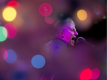 Darrell Barr is photographed through a Christmas Tree as he performs during the Holiday Light Up festivities in Churchill Square, in Edmonton on Saturday Nov. 12, 2016.