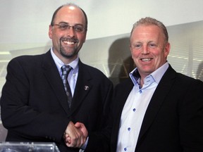 Jeff Hunt, president of Ottawa Sports and Entertainment Group (right),shakes hands with Marcel Desjardins as he is named the general manager of the new Ottawa CFL franchise in Ottawa, Wednesday, January 30 2013.