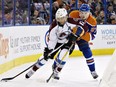 Colorado Avalanche's Jarome Iginla (12) and Edmonton Oilers' Connor McDavid (97) battle for the puck during first period NHL action in Edmonton, Alta., on Sunday March 20, 2016.