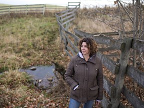 Lonni Saken is pictured by a contaminated source of water on her farm near Edson, Alta., on Friday, Oct. 30, 2015. An Alberta energy company has been ordered to transport water to a family dairy farm where the ground water has been contaminated by chemicals from a nearby gas plant.