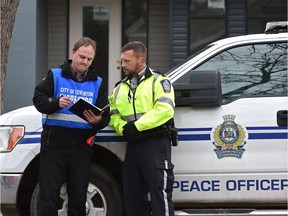 Members of the infill compliance team, Peace Officer Darren Anderson (right) and James Bailey, compliance officer, are part of the infill compliance team launched in July in response to citizen complaints in Edmonton, Thursday, October 13, 2016.