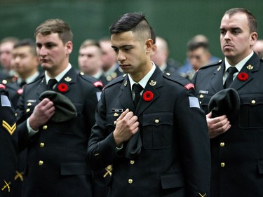 Members of the military lower their head dress during the playing of The Last Post during a Remembrance Day ceremony in Edmonton on Friday November 11, 2016.