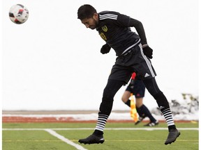 Caption correction  University of Alberta Golden Bears' Ajeej Sarkaria heads in a goal against the MacEwan University Griffins' during men's soccer action at the Jasper Place Bowl, in Edmonton on Sunday Oct. 9, 2016.