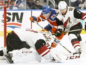 Arizona Coyotes goalie Mike Smith (41) makes the save as Edmonton Oilers' Ryan Nugent-Hopkins (93) and Luke Schenn (2) battle in front during second period NHL action in Edmonton, Alta., on Sunday November 27, 2016.