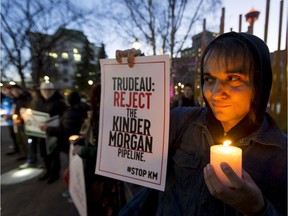 Neil Abouelwafa joins a crowd of protesters at Olympic Plaza in downtown Calgary, Alta., on Monday, Nov. 21, 2016. More than 50 people were part of a protest against Kinder Morgan's proposal to expand and triple the capacity of its existing Trans Mountain pipeline from Strathcona County to the B.C. coast. Lyle Aspinall/Postmedia Network