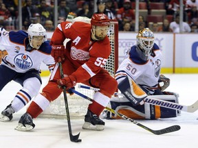 Detroit Red Wings defenseman Niklas Kronwall (55) of Sweden looks to pass as he is blocked from the net by Edmonton Oilers right wing Tyler Pitlick (15) and goalie Jonas Gustavsson (50) of Sweden during the second period of an NHL hockey game in Detroit, Sunday, Nov. 6, 2016.