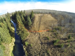 Off-highway vehicle ruts on a steep slope, and EALT volunteers installing a snow fence to prevent further damage.