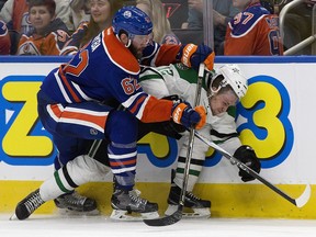 The Edmonton Oilers' Eric Gryba (62) checks the Dallas Stars' Radek Faksa (12) during third period NHL action at Rogers Place, in Edmonton on Friday Nov. 10, 2016.