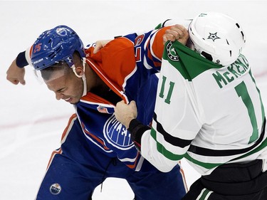 The Edmonton Oilers' Darnell Nurse (25) fights the Dallas Stars' Curtis McKenzie (11) during first period NHL action at Rogers Place, in Edmonton on Friday Nov. 10, 2016.