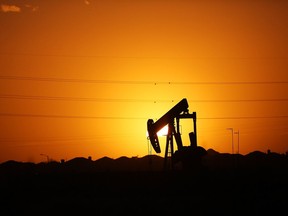 A pumpjack sits on the outskirts of town at dawn in the Permian Basin oil field on January 21, 2016 in the oil town of Midland, Tex.