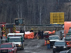 Police and fire personnel are lifted out of a tunnel as they responded to a workplace death underground at a sanitary sewer construction project in southwest Edmonton Tuesday Nov. 1, 2016