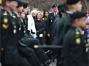 Premier Rachel Notley prepares to march with the South Alberta Light Horse regiment to the cenotaph in Light Horse Park for a Remembrance Day ceremony Friday, Nov. 11, 2016.