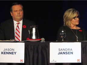 Progressive Conservative candidates Jason Kenney, a former Conservative MP, and Sandra Jansen sit next to each other during the Alberta Progressive Conservative party leadership forum in Red Deer on Nov. 5, 2016. The only two female candidates in the Alberta Progressive Conservative leadership race are calling it quits, one of them citing Trump-style intimidation tactics in the campaign.
