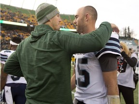 Toronto Argonauts quarterback Ricky Ray (15) is hugged by Edmonton Eskimos head coach Jason Maas after the game during CFL action in Edmonton, Alta., on Saturday November 5, 2016.