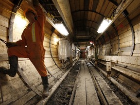 A worker performs maintenance on a new sewer tunnel being drilled deep below the North Saskatchewan River at Dawson Park in 2007.