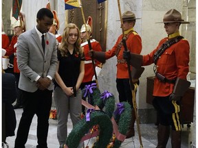 Moses Ndekezi (left) and Lucille Bergmann (right), representing the Youth of Alberta, lay a wreath at the Service of Remembrance held at the Alberta Legislature on November 3, 2016.