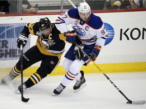 Edmonton Oilers' Connor McDavid (97) and Pittsburgh Penguins' Sidney Crosby (87) compete for the puck during the first period of an NHL hockey game in Pittsburgh, Tuesday, Nov. 8, 2016.