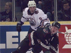 Edmonton Oilers forward Bill Guerin trips up Phoenix Coyotes forward Keith Tkachuk during NHL action at Skyreach Centre in Edmonton on Dec. 2, 1998.