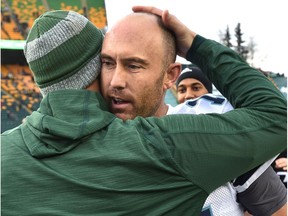 This could be the last game played for Toronto Argonauts quarterback Ricky Ray (R) as he gets a hug from former teammate Edmonton Eskimos head coach Jason Maas during CFL action at Commonwealth Stadium in Edmonton, Saturday, November 5, 2016.